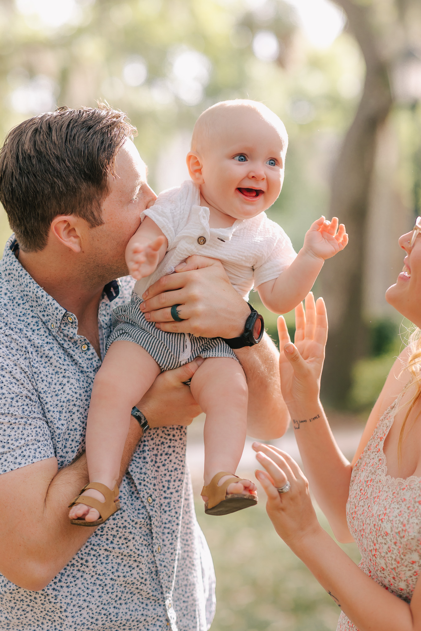 9 month old boy laughing at young parents while bouncing up and down for laughs. Things to do in Savannah, ga with kids