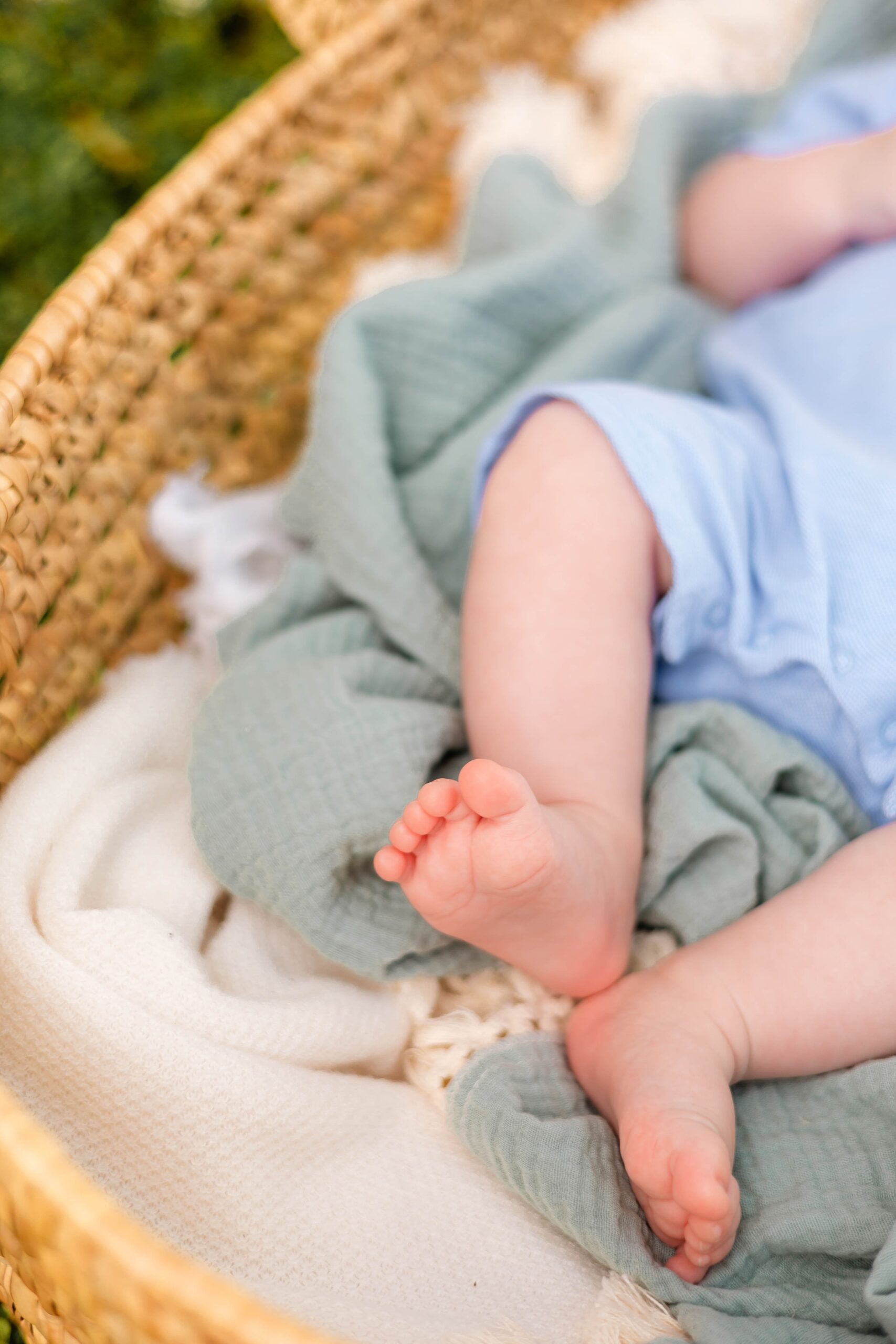 Details of a newborn baby's feet in a woven basket before exploring a montessori school savannah