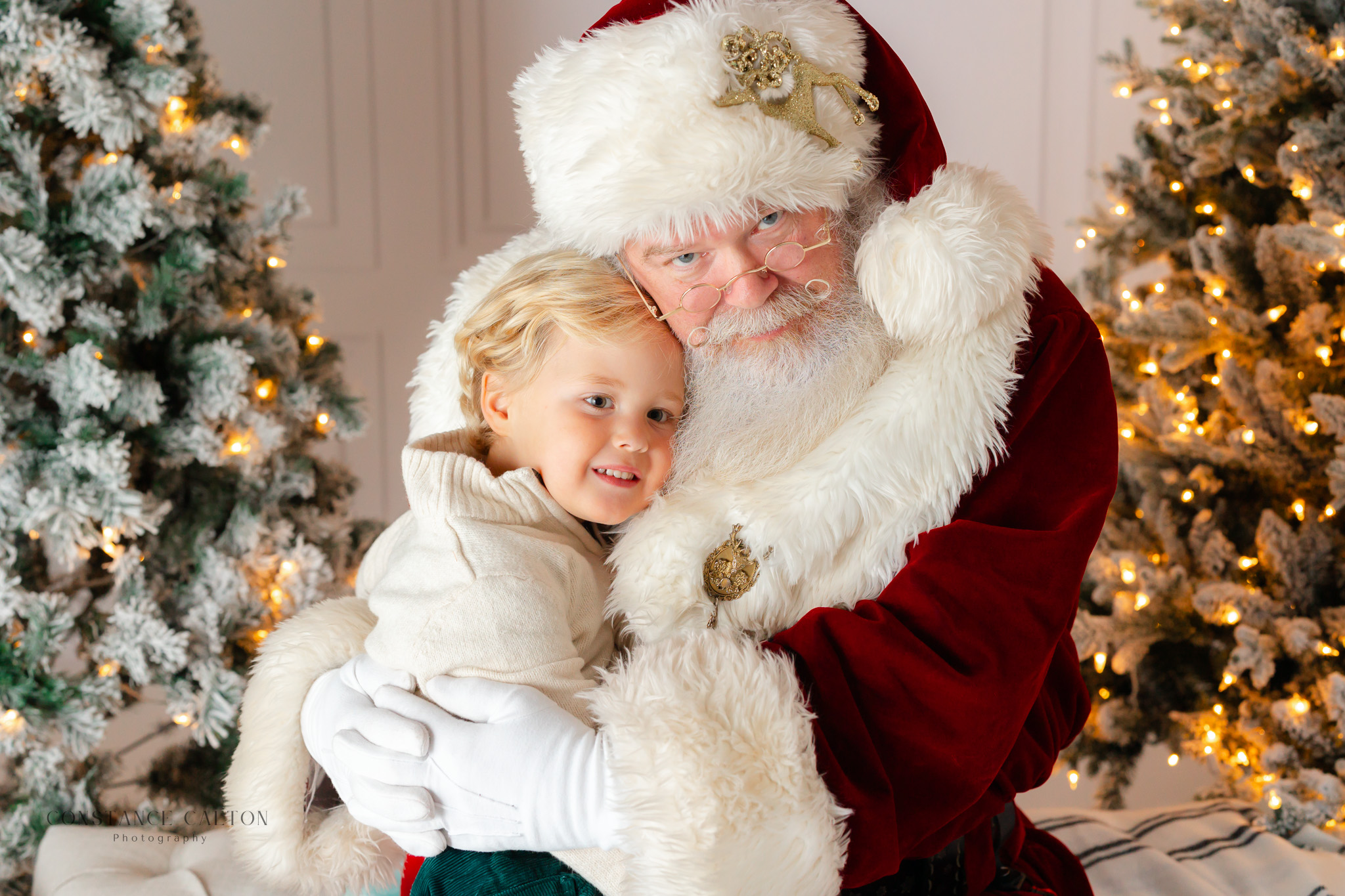 Little boy and santa hugging during a Savannah Santa session with Constance Calton Photography