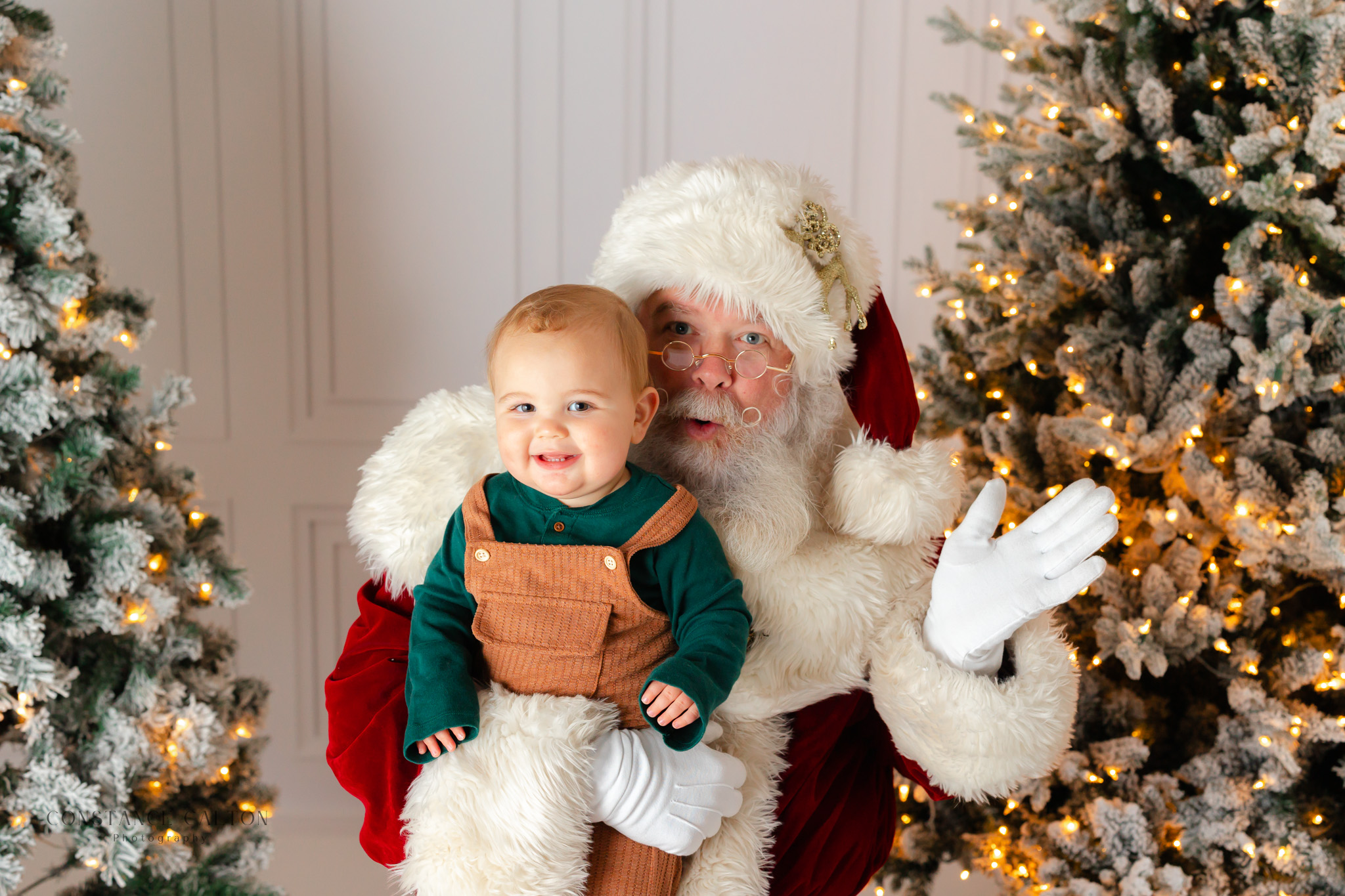 Studio Santa smiling with a little during Savannah Santa Pictures