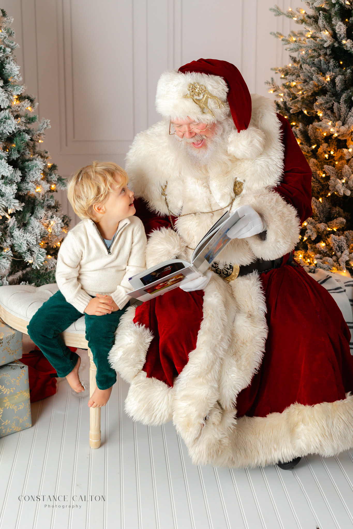 Child smiling while listening to Studio Santa read a story during Savannah Santa Pictures session