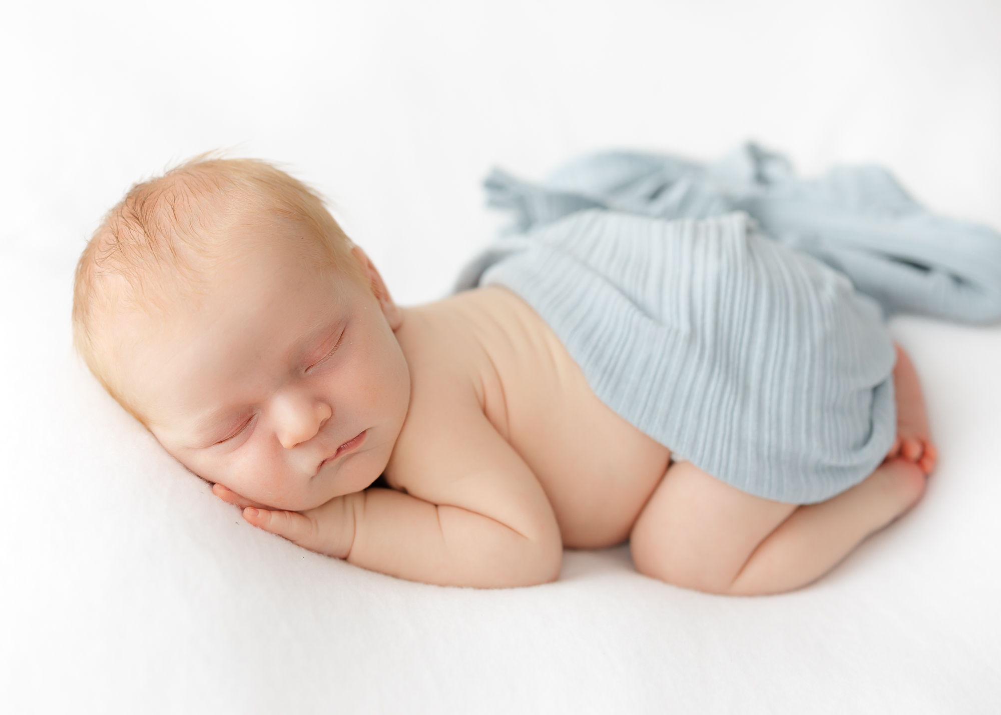 Savannah newborn photographer creating classic curled-up newborn portrait.