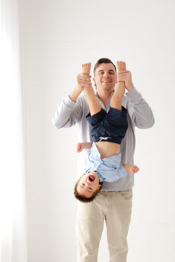 A young dad and his little boy being silly at a photoshoot in Savannah, ga