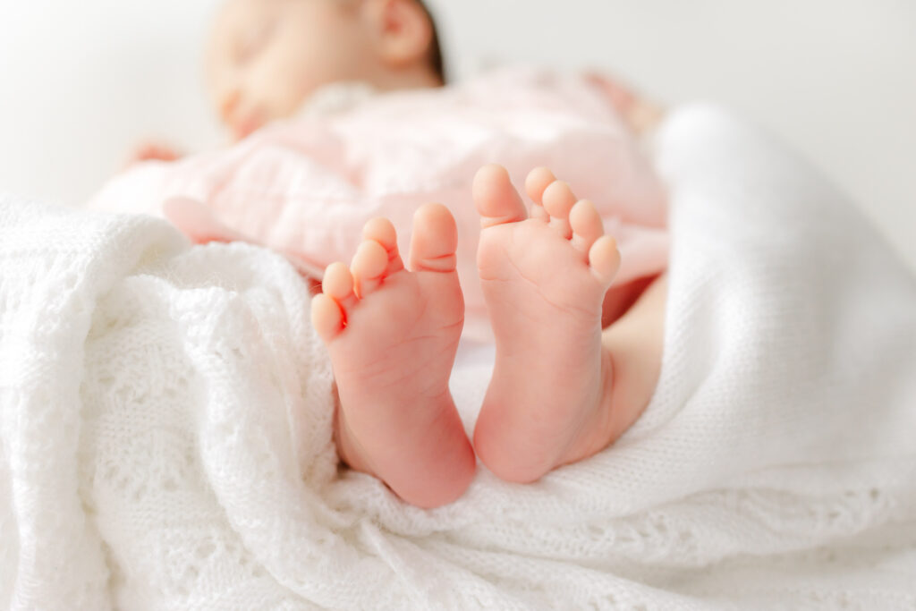 Close up of newborn baby girl's tiny feet during her Savannah newborn photography session.