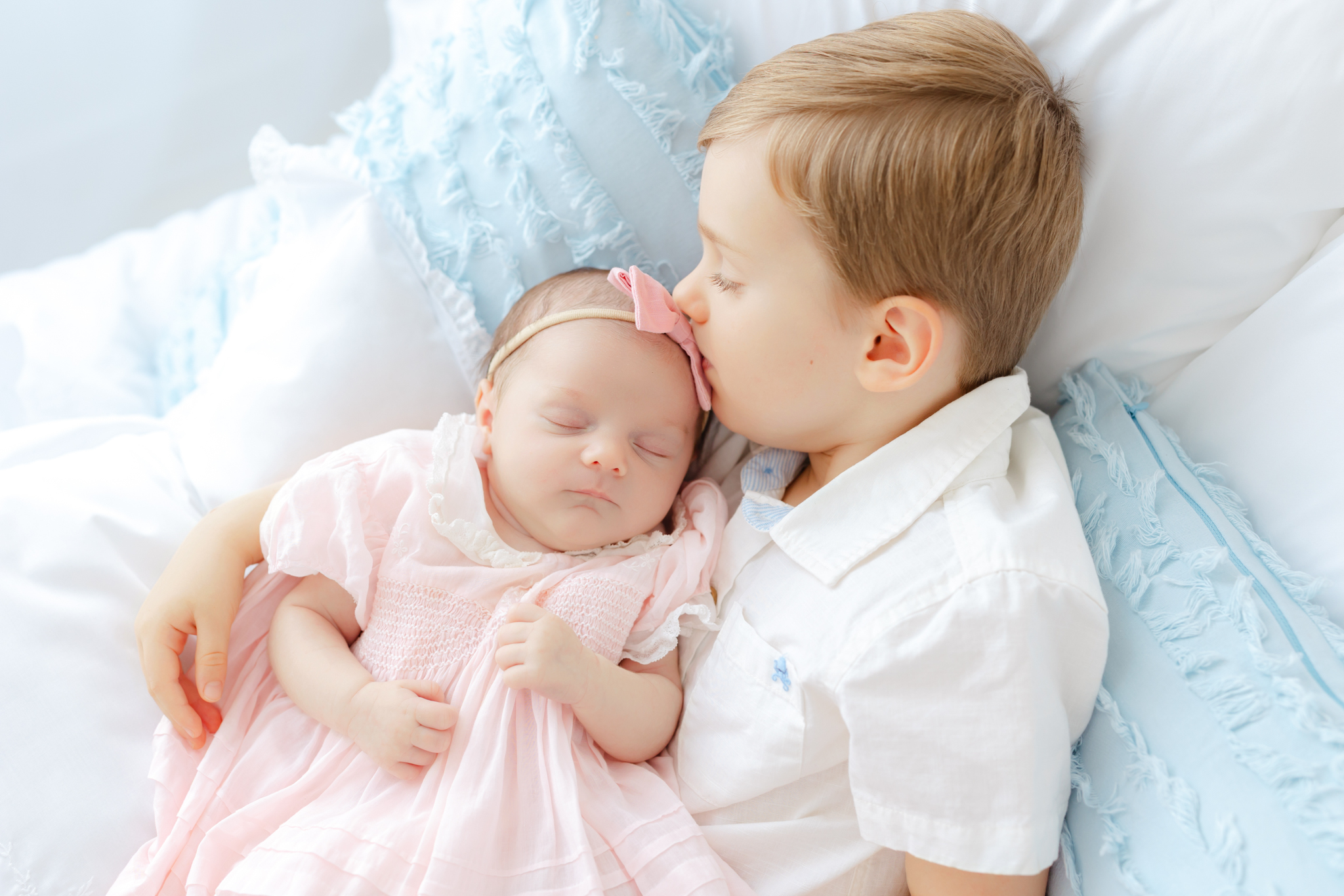 three year old boy kissing his newborn sister at their newborn session in Savannah, ga